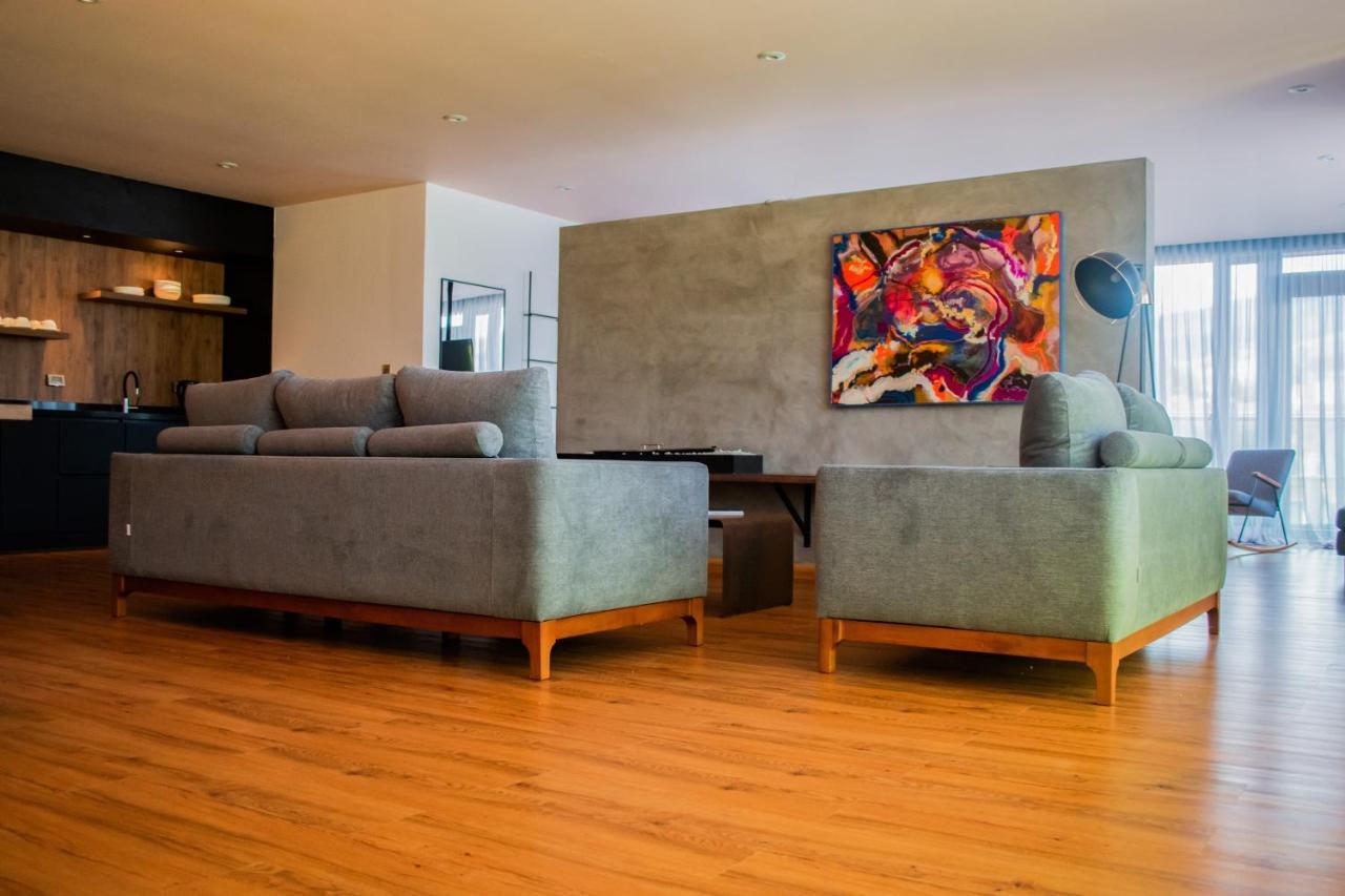 Hotel V1501 Pasto Dış mekan fotoğraf A living room with a concrete wall